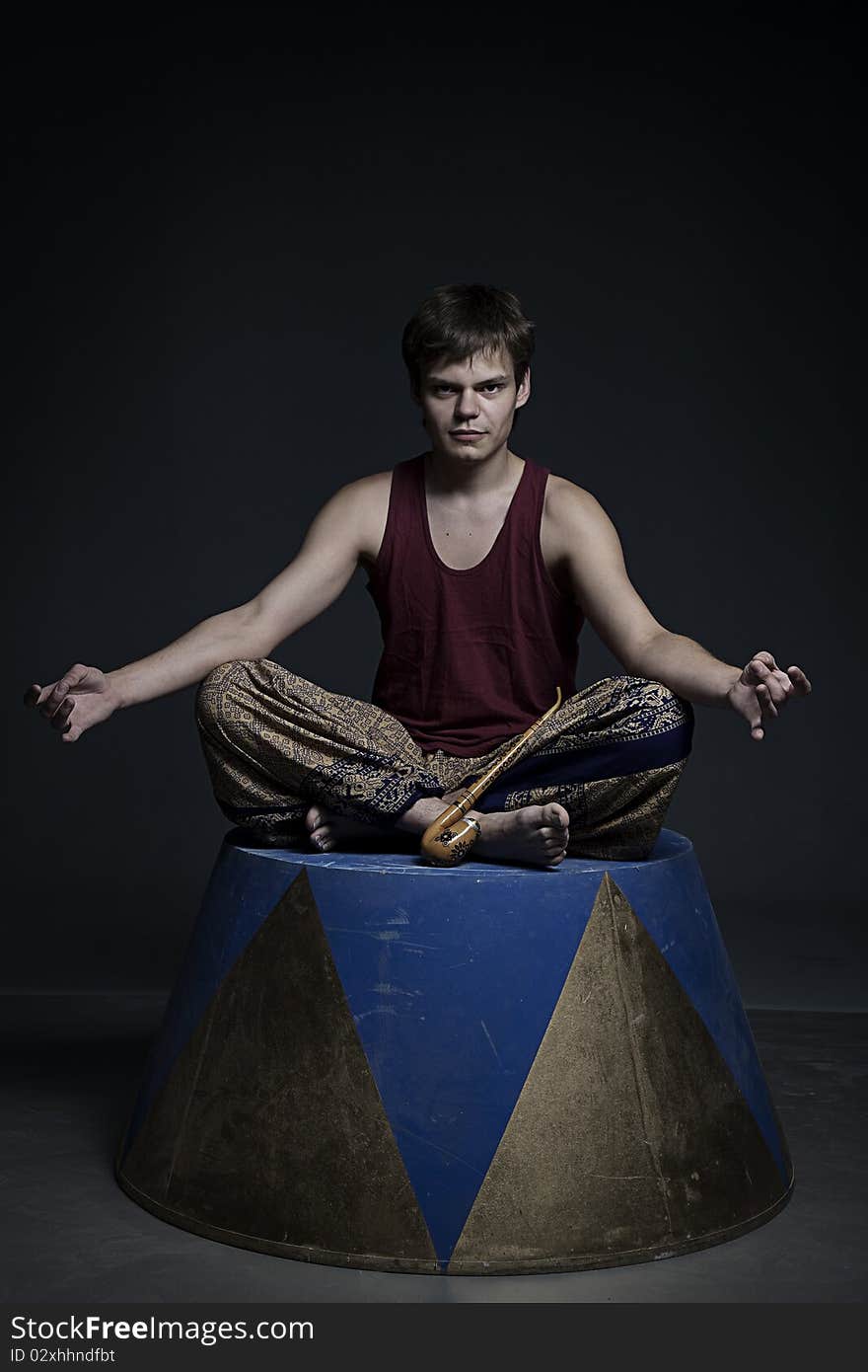 Circus actor posing on curbsone in studio