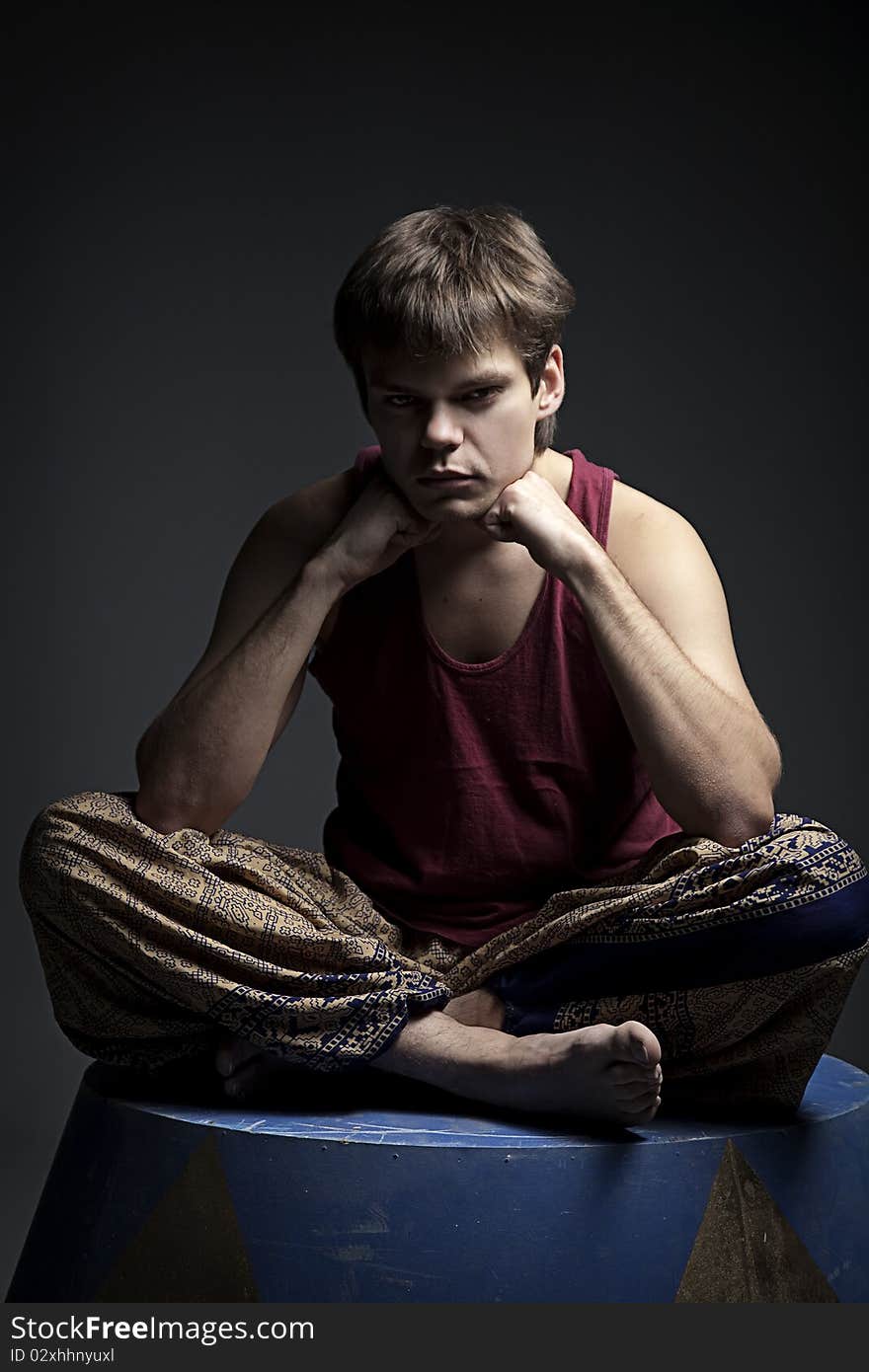 Circus actor posing on curbsone in studio