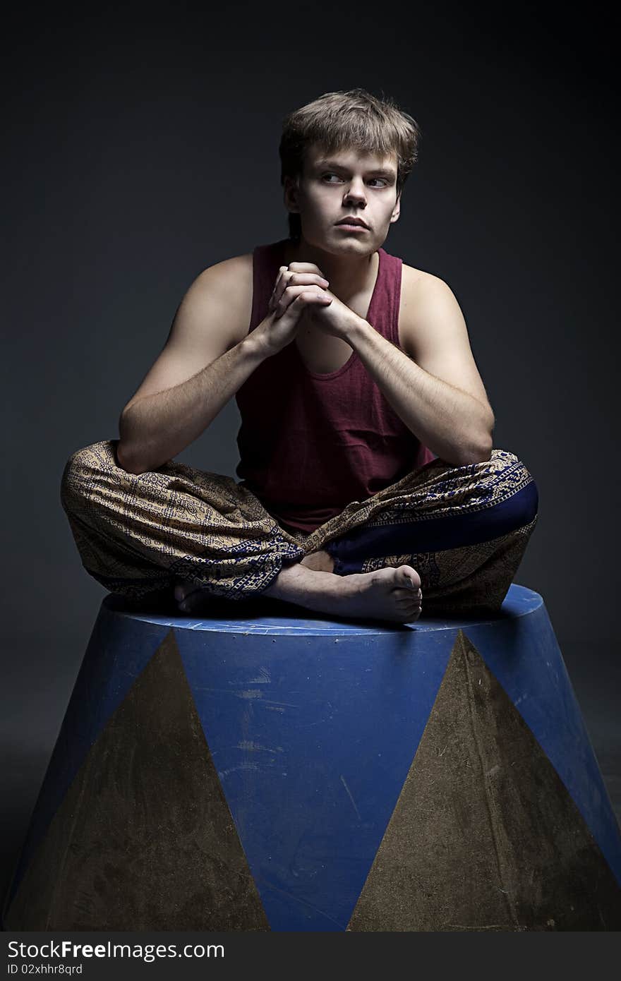 Circus actor posing on curbsone in studio