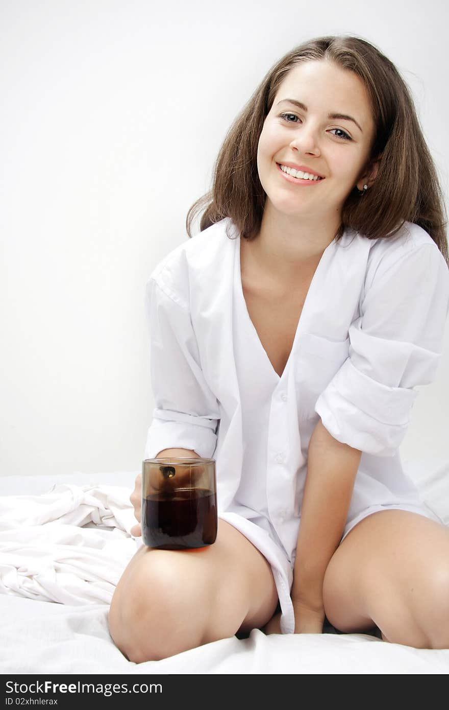 Young Attractive Woman With Cup Of Tea In Bed