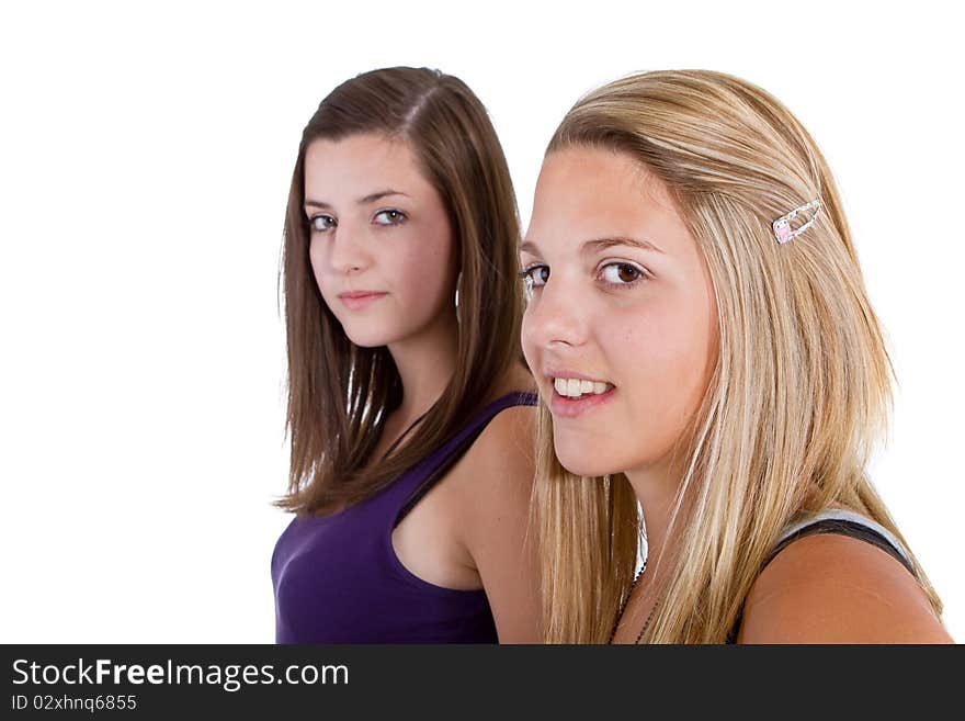 Two young girl friends smiling - isolated over white background. Two young girl friends smiling - isolated over white background.