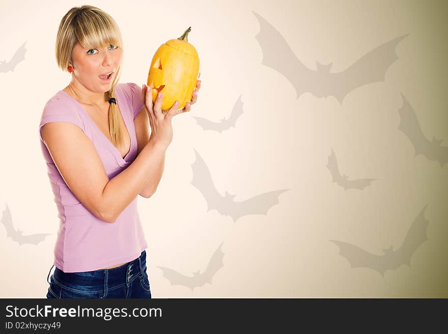 A young girl frightened with pumpkin for Halloween