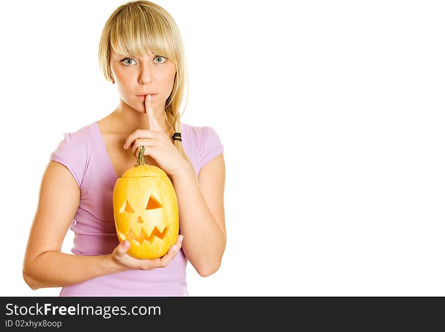 A young girl frightened with pumpkin for Halloween. Gesturing for Quiet or Shushing. Lots of copyspace and room for text on this isolate. A young girl frightened with pumpkin for Halloween. Gesturing for Quiet or Shushing. Lots of copyspace and room for text on this isolate