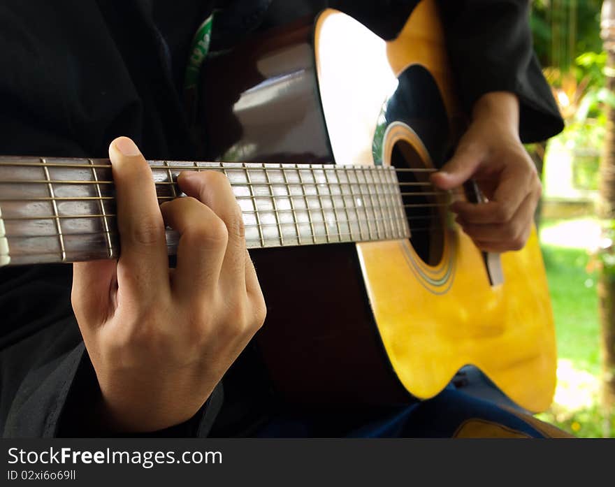 Man playing folk guitar with left hand