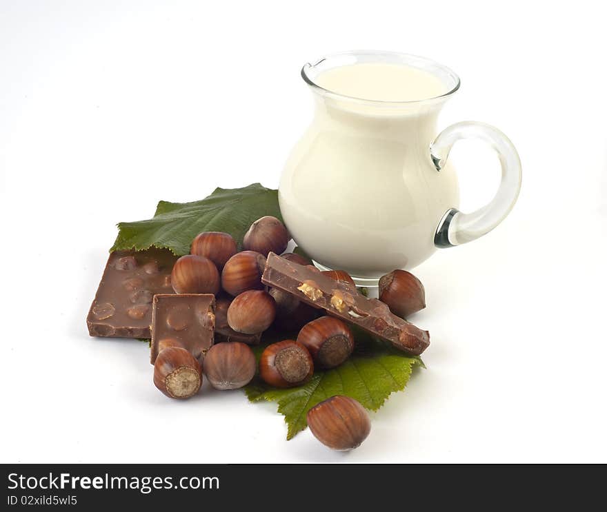 Chocolate hazelnut and milk jug on a white background. Chocolate hazelnut and milk jug on a white background