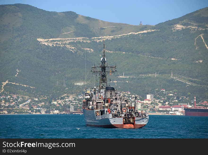 Ship against the wooded mountains