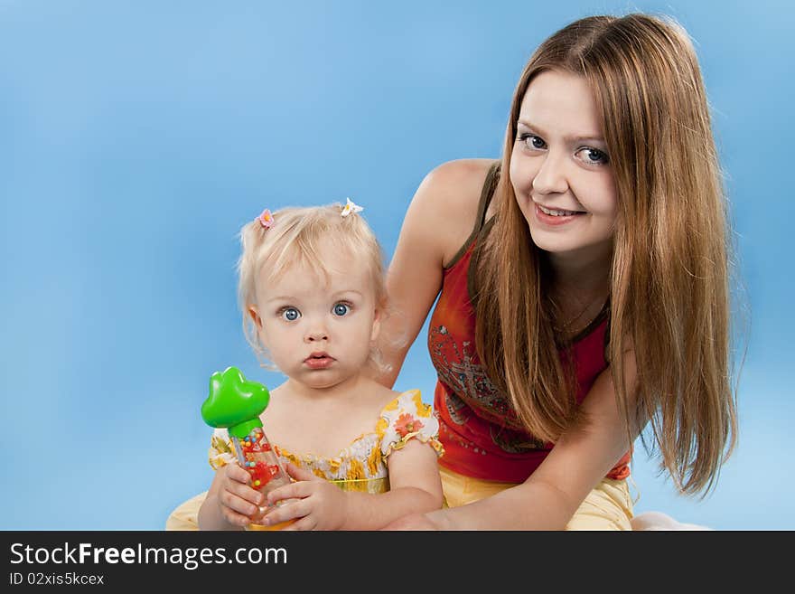 Small lovely girl on a blue background.