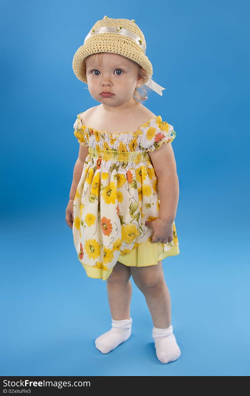 Beautiful little girl the blonde on a blue background. Beautiful little girl the blonde on a blue background