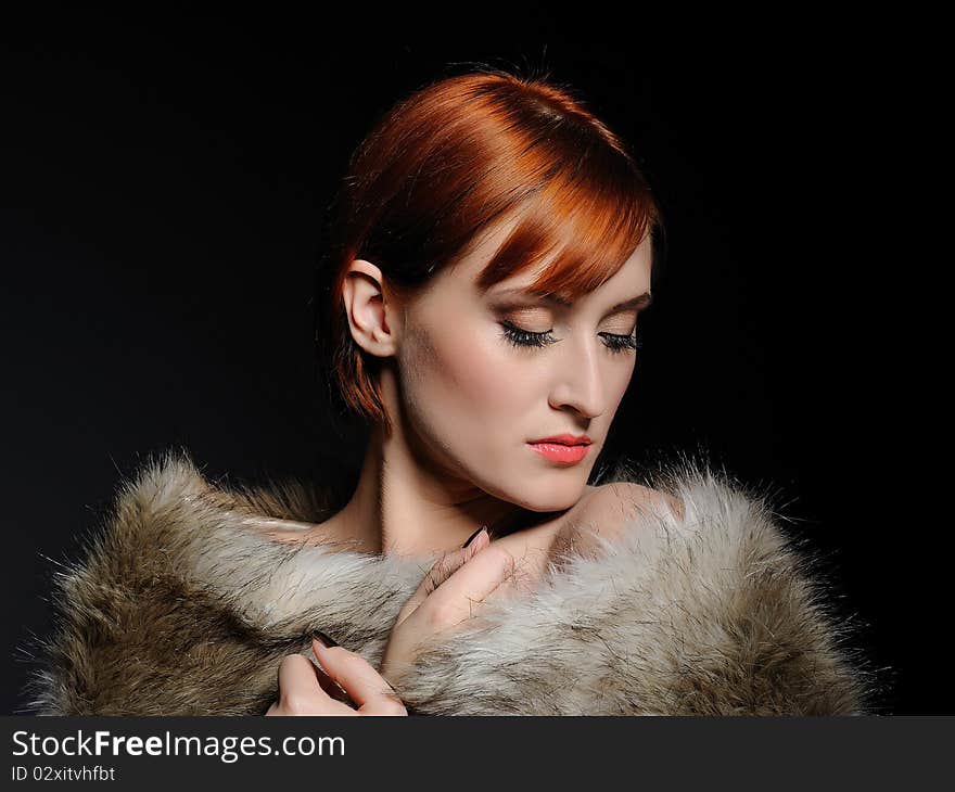 Beautiful woman with party make-up and fur