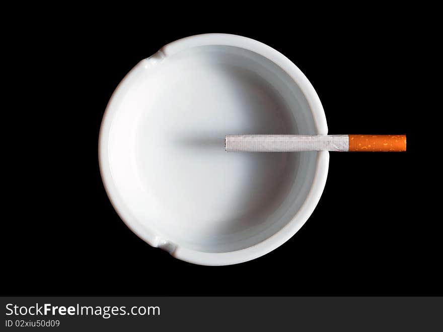 Cigarette ashtray in white on a black background. Cigarette ashtray in white on a black background