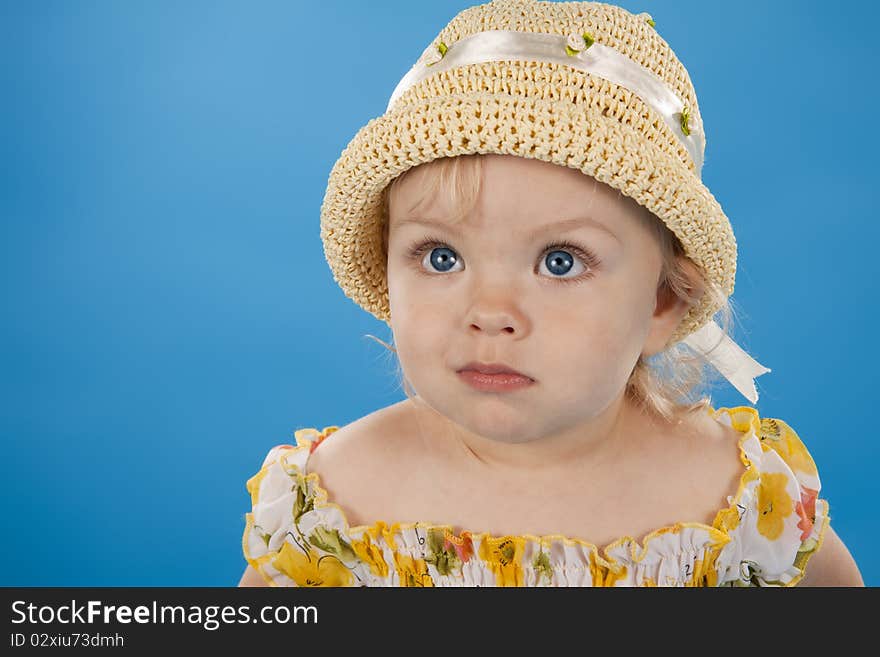 Lovely little girl in a hat looks upwards. Lovely little girl in a hat looks upwards