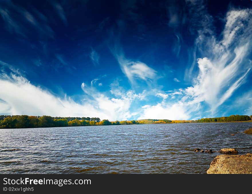 Wonderful autumn lake and blue sky with white clouds. Wonderful autumn lake and blue sky with white clouds.