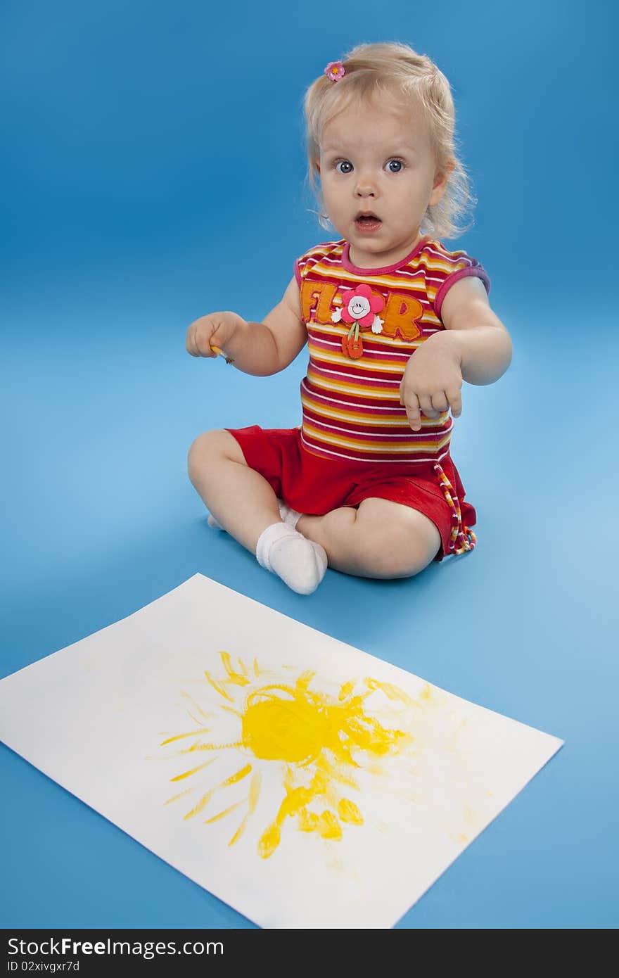 Small artist draw paints the sun. Isolated blue. Small artist draw paints the sun. Isolated blue.