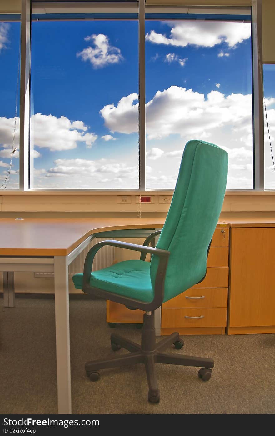 Chair, and blue sky in window. Chair, and blue sky in window