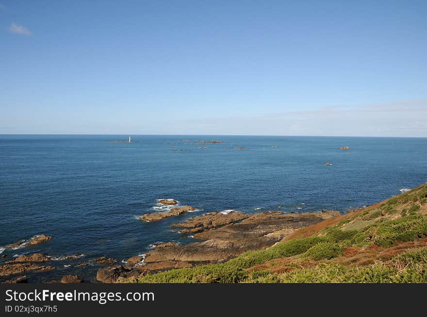 Coast of Guernsey at Torteval with lighthouse out at sea