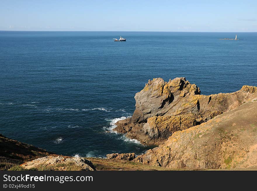 Coast of Guernsey at Torteval with lighthouse out at sea