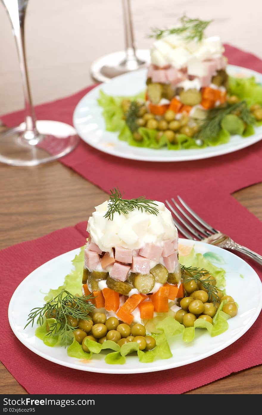 Two plates with salad on a white background. Two plates with salad on a white background