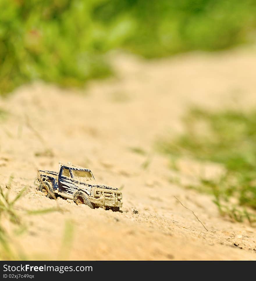 Toy truck in sand (tilt-shift). Toy truck in sand (tilt-shift)