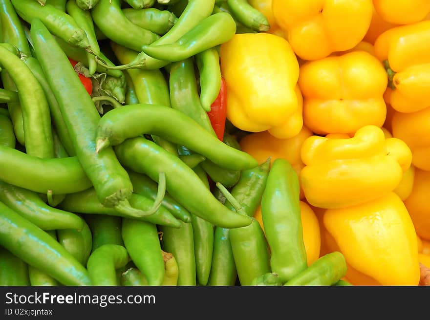 Close up of yellow and green peppers on market stand