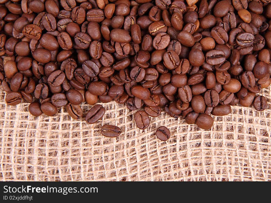 Coffee beans on burlap material in close up