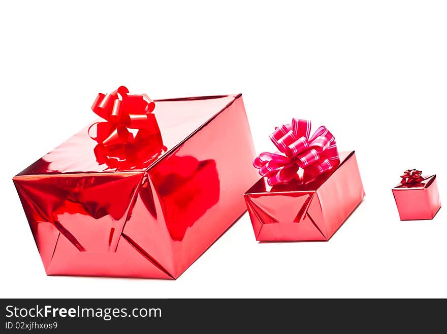 Row from red christmas gifts boxes with bows. Isolated on white. Row from red christmas gifts boxes with bows. Isolated on white