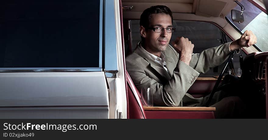 Handsome man sitting in the car