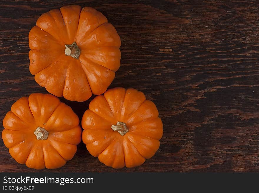 Small orange pumpkins symbolising autumn holidays and used in decorative works.