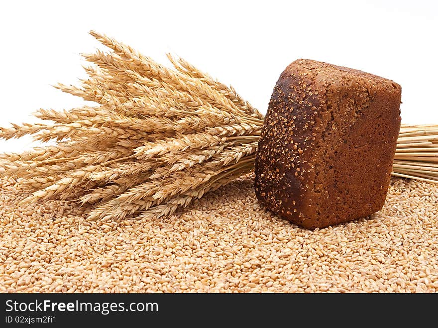 Bread with wheat and ears on white