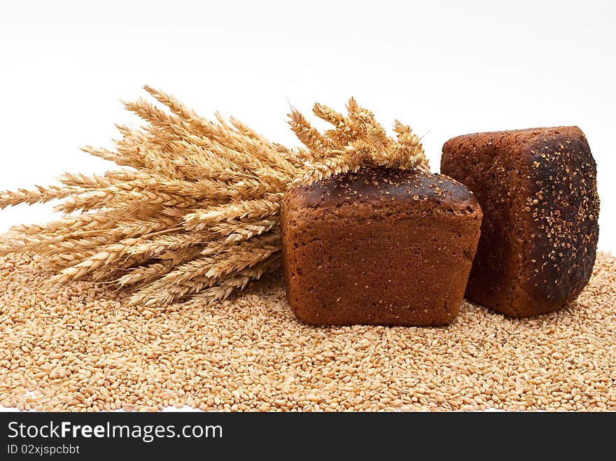 Bread with wheat and ears on white