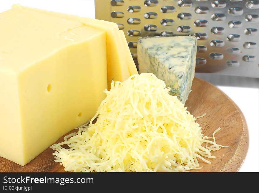 Cheeses on wooden board