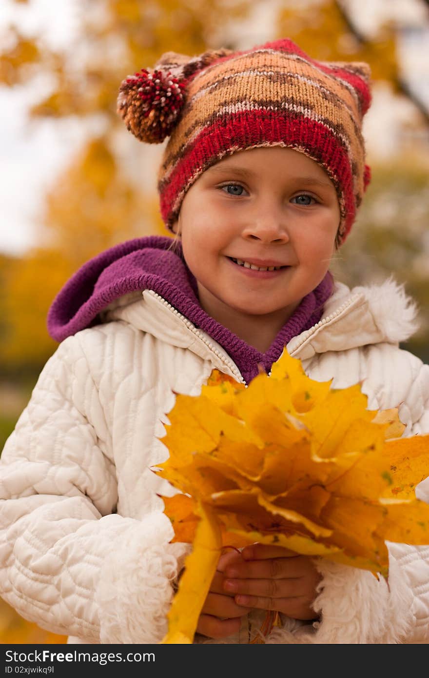 Girl with a heap of leaves