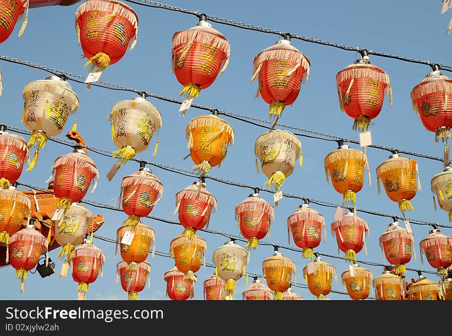 Rows Of Red Silk Lanterns Hanging Outside A Temple. Rows Of Red Silk Lanterns Hanging Outside A Temple