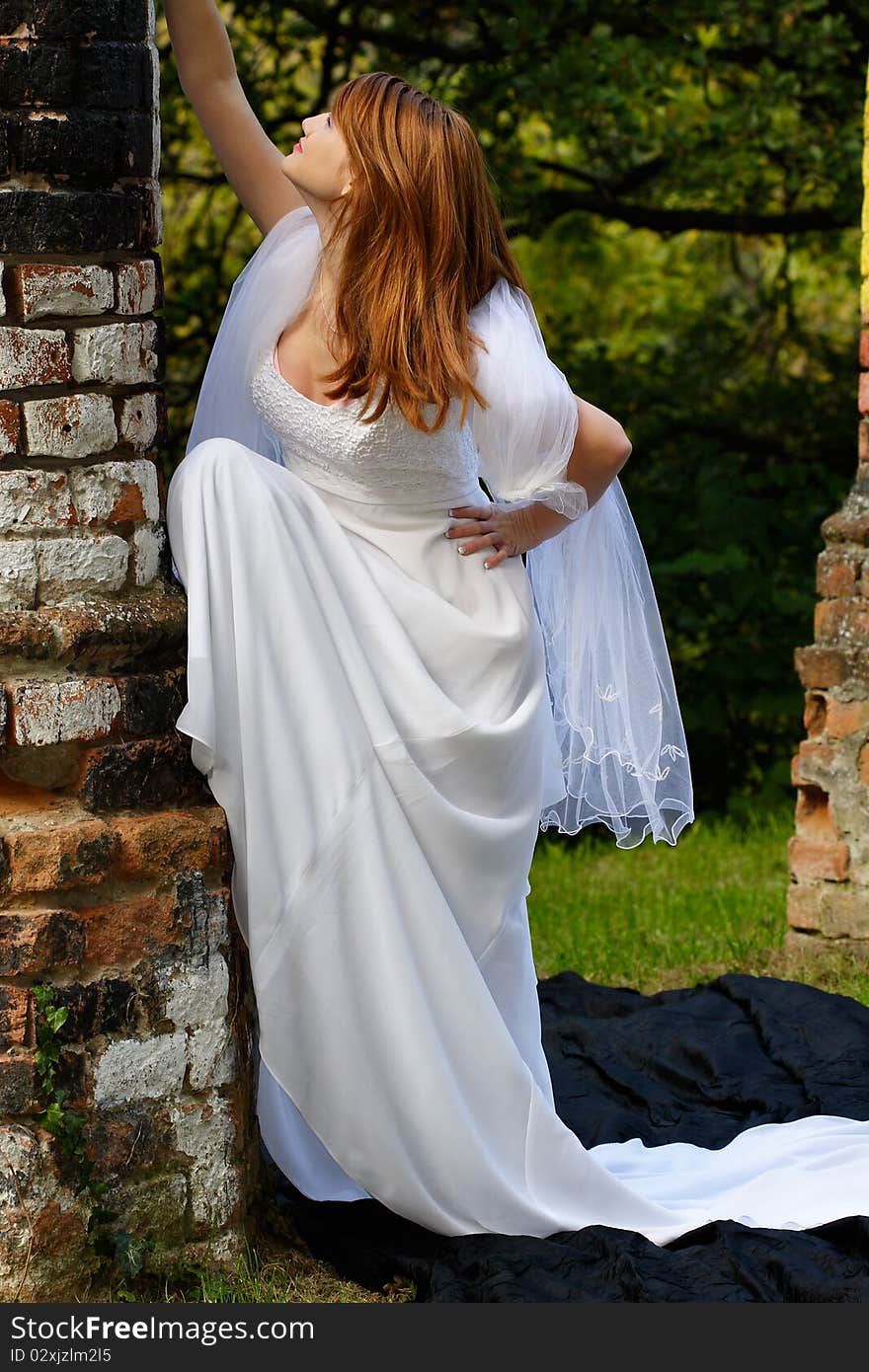 Beautiful woman posing in a white dress in the nature. Beautiful woman posing in a white dress in the nature