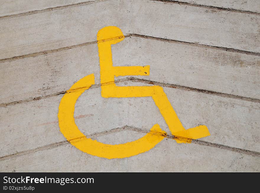 Yellow Wheel Chair Sign On The Floor