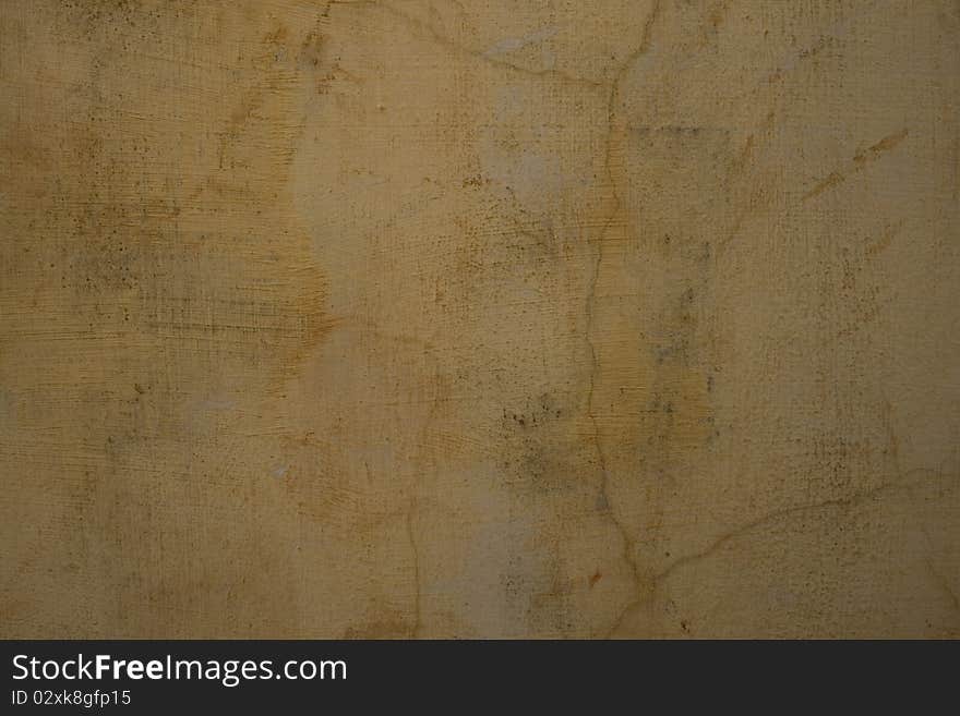 Sandy pale grey cracked plaster wall