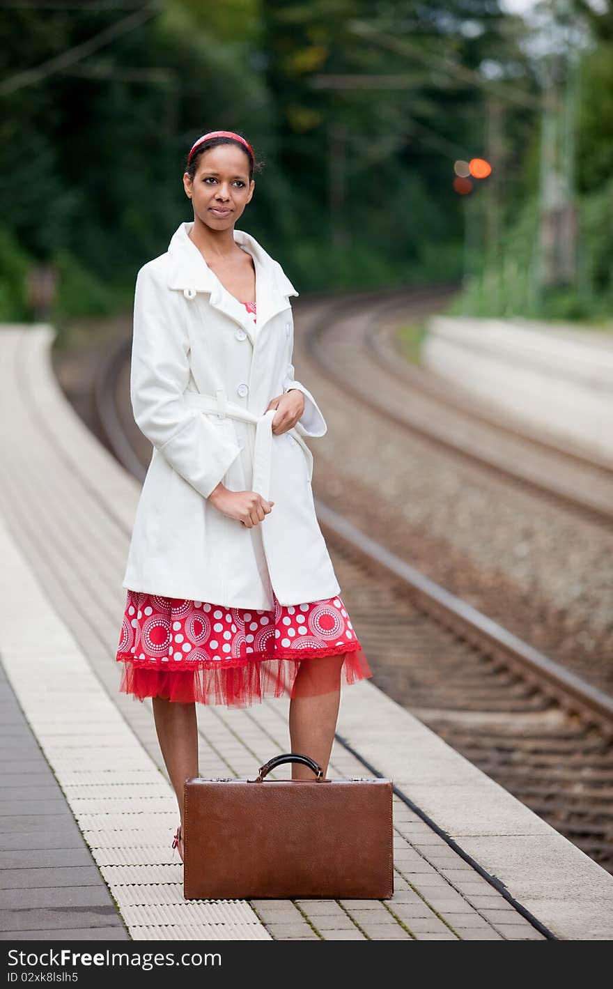 An afro-american lady waits for the train. An afro-american lady waits for the train