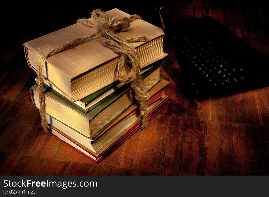 Sheaf of old books and the laptop