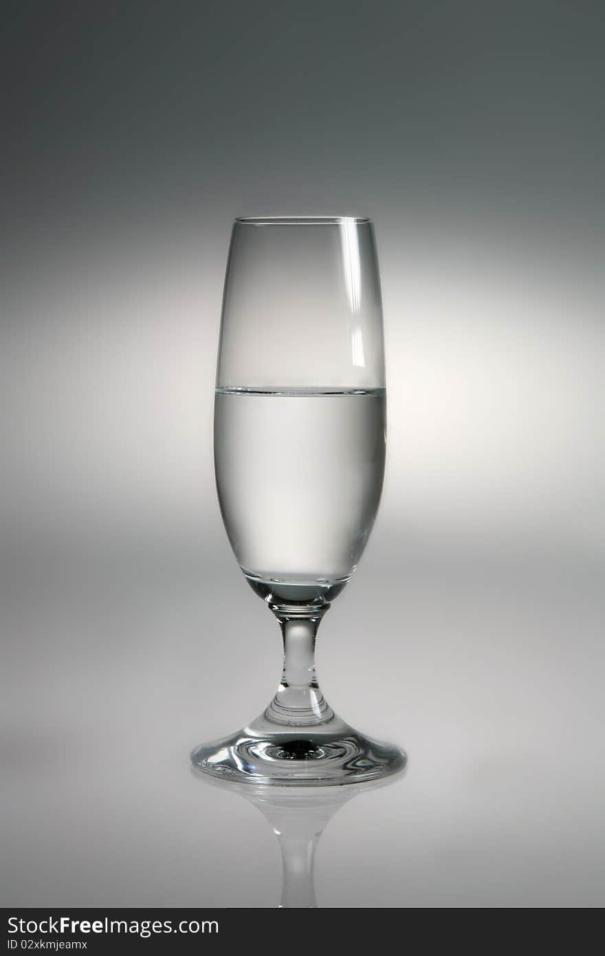 Glass of water on neutral background