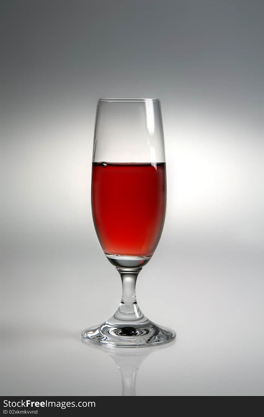 Glass of red wine on neutral background