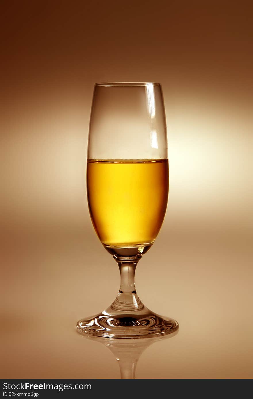 Glass with yellow drink in warm atmosphere. Glass with yellow drink in warm atmosphere