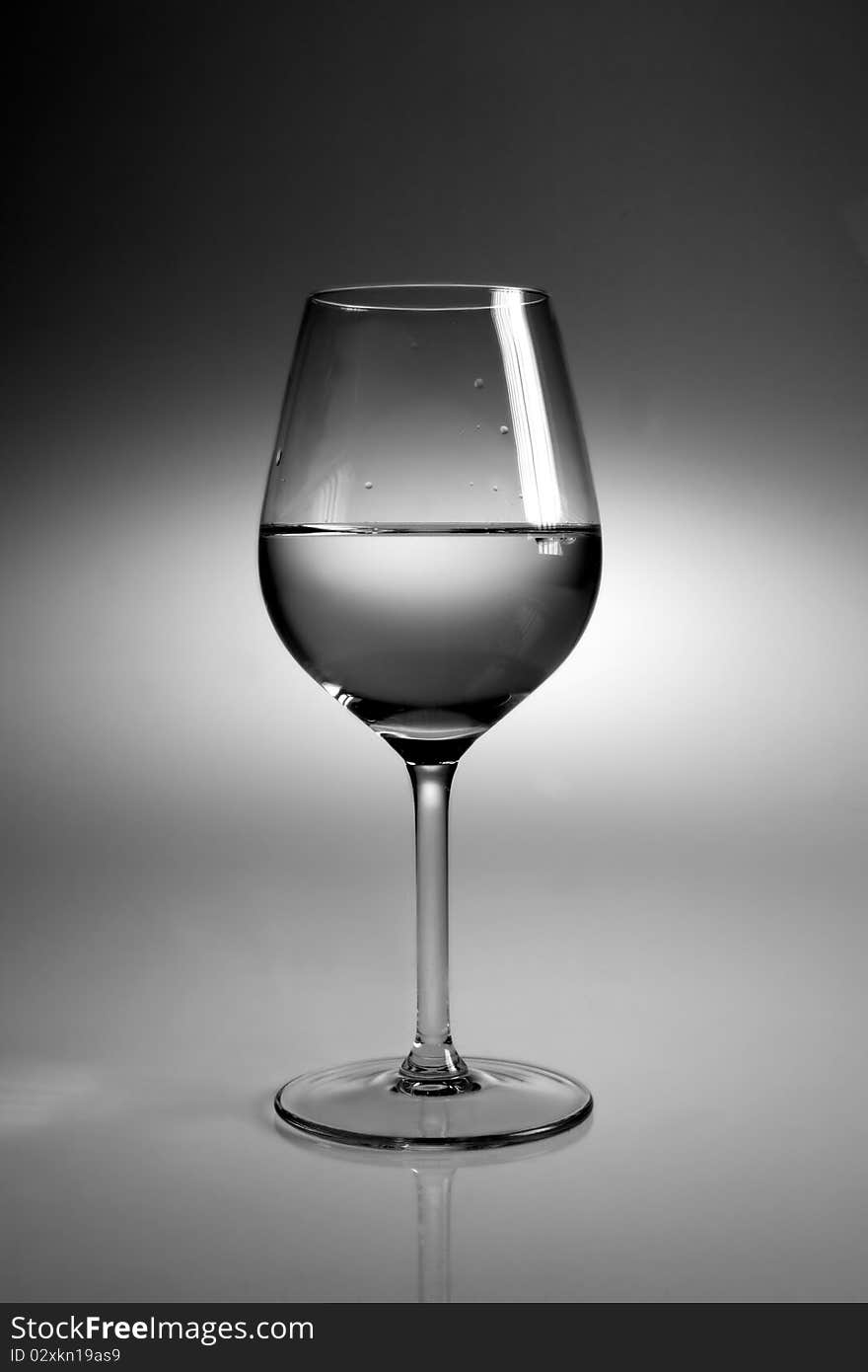 Glass of water on neutral background