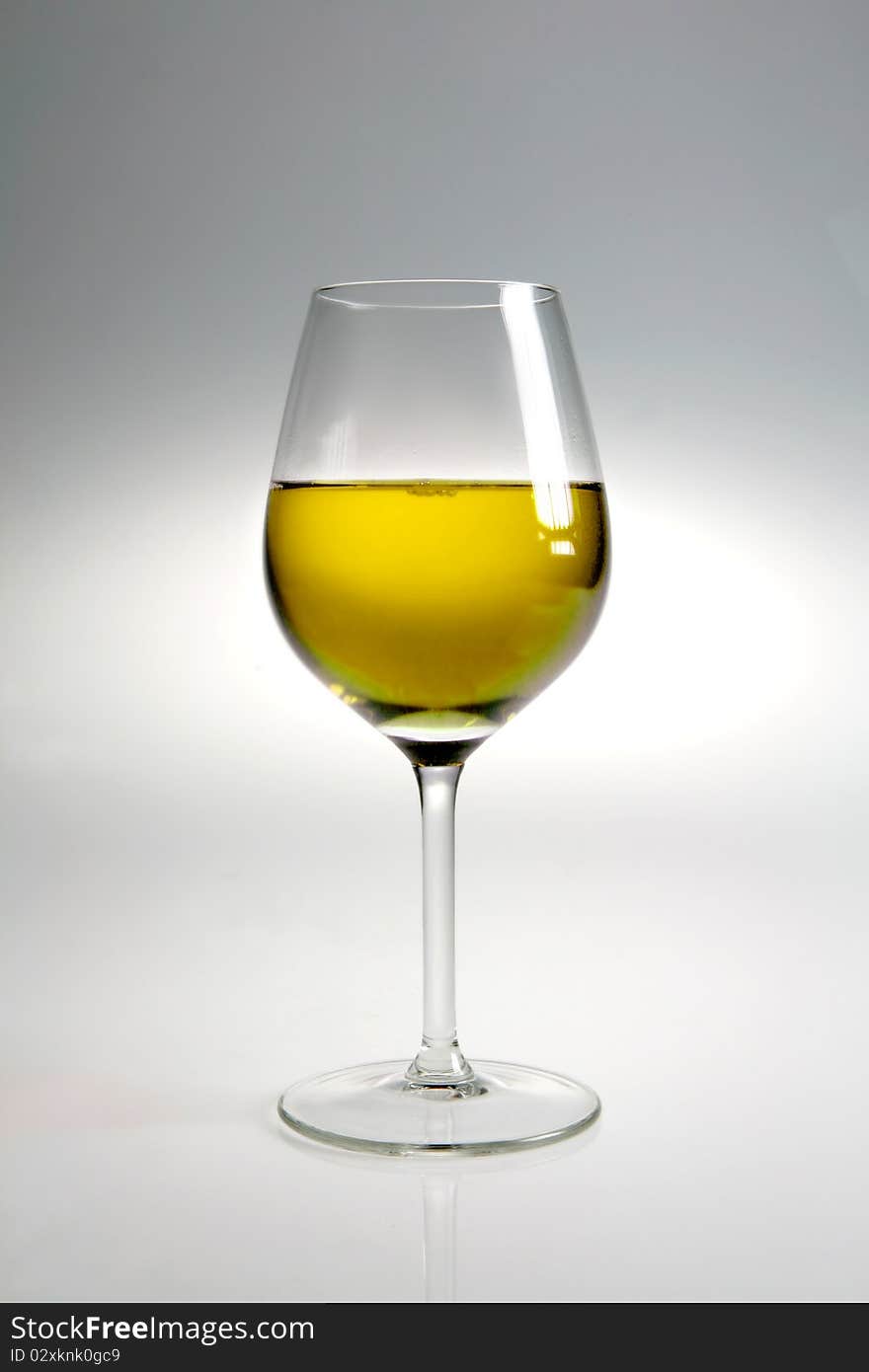 Glass with white wine on neutral background