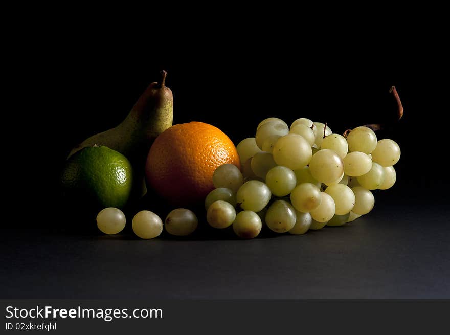 Mixed fruit still life art on a black background. Mixed fruit still life art on a black background