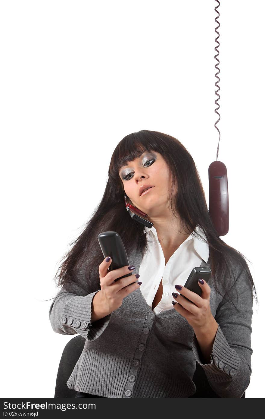 Businesswoman speak by four phones at the same time on her workspace