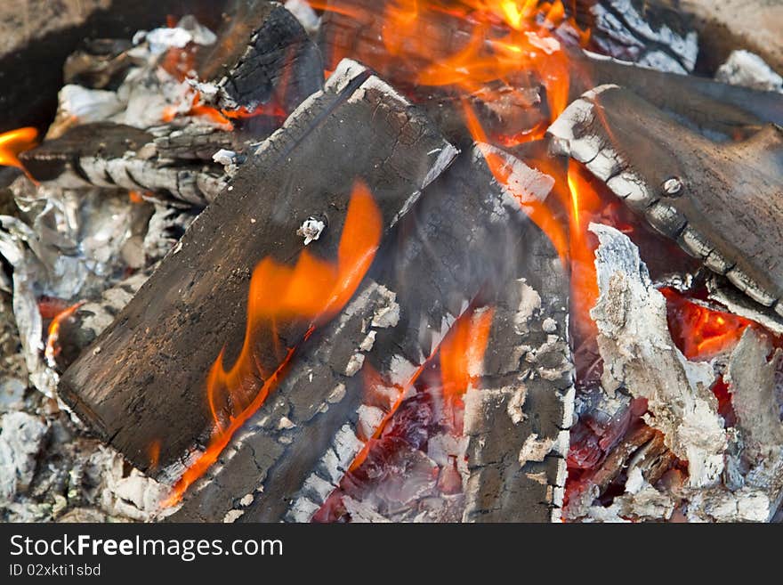 Hot embers from an evening campfire.