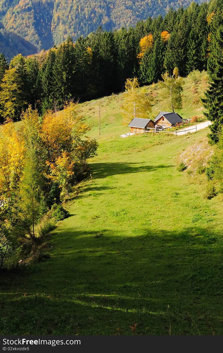 Small wooden lodge with grassland in the mountains of the Hochbaerneck in Lower Austria on a sunny autumn day. Small wooden lodge with grassland in the mountains of the Hochbaerneck in Lower Austria on a sunny autumn day