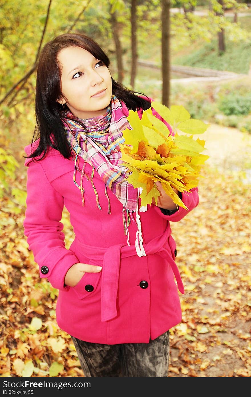 Pensive girl with the bouquet of leaves