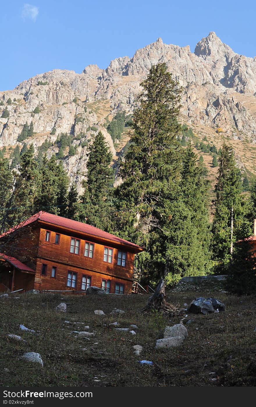 Simple living: Wooden house close to Mountain top in tien shan mountains near almaty kazakhstan on a sunny fall day. Simple living: Wooden house close to Mountain top in tien shan mountains near almaty kazakhstan on a sunny fall day