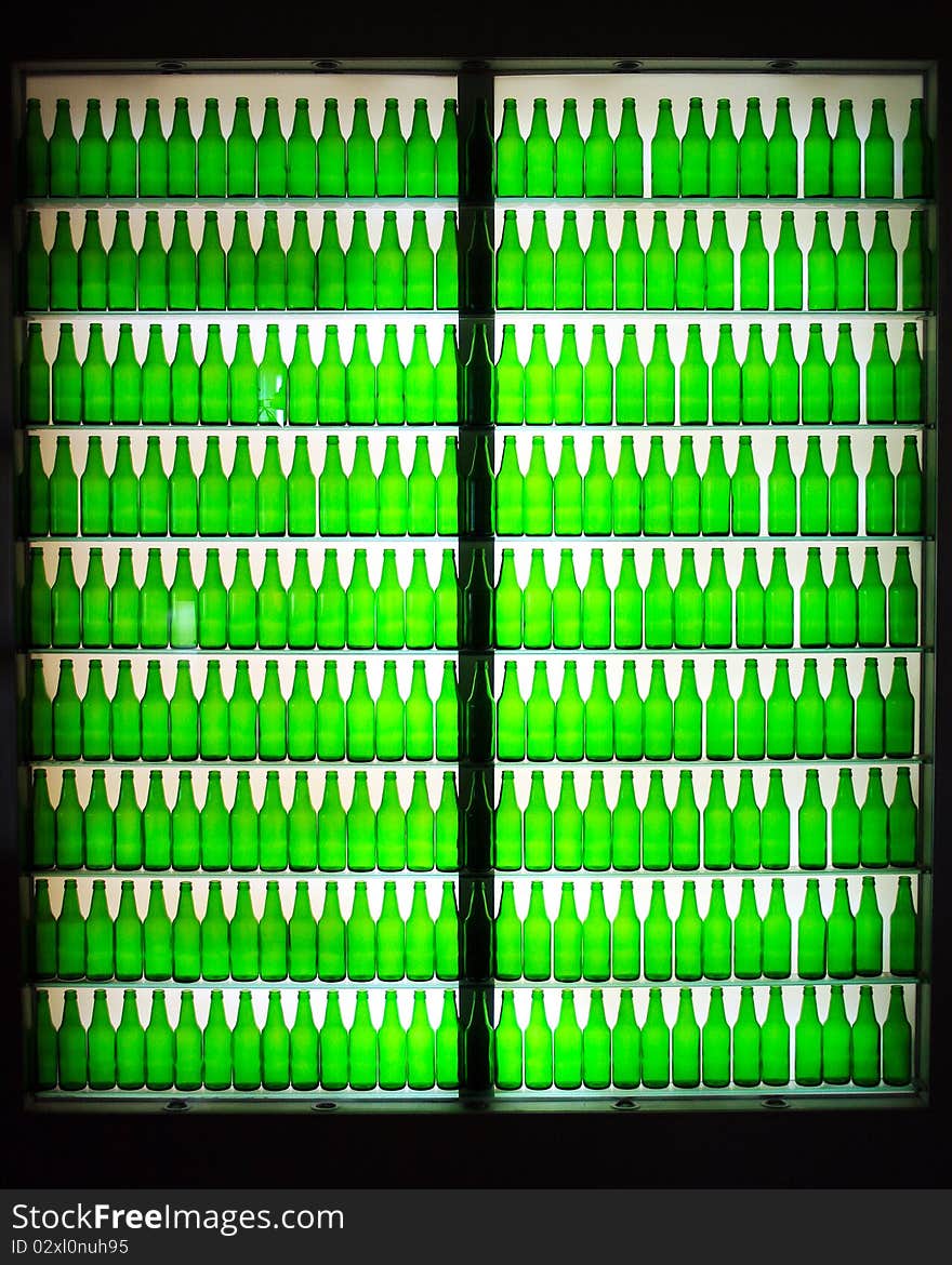 The silhouette rows of the green bottles.