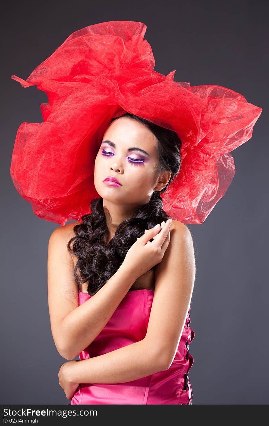 Beautiful Brunette Woman In Red Tulle Hat